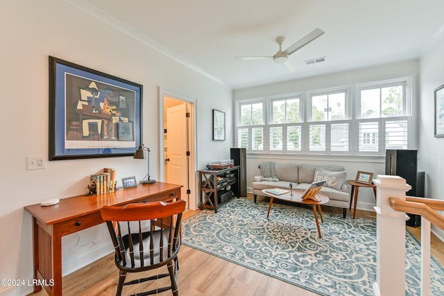 interior space featuring hardwood / wood-style flooring, ornamental molding, and ceiling fan