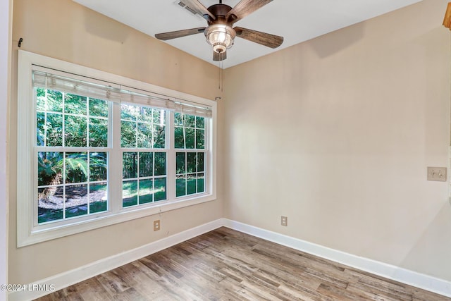 unfurnished room with hardwood / wood-style floors and ceiling fan