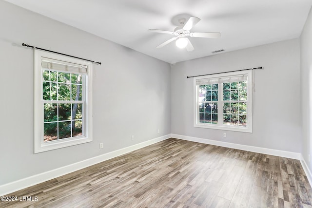 empty room with ceiling fan and light wood-type flooring