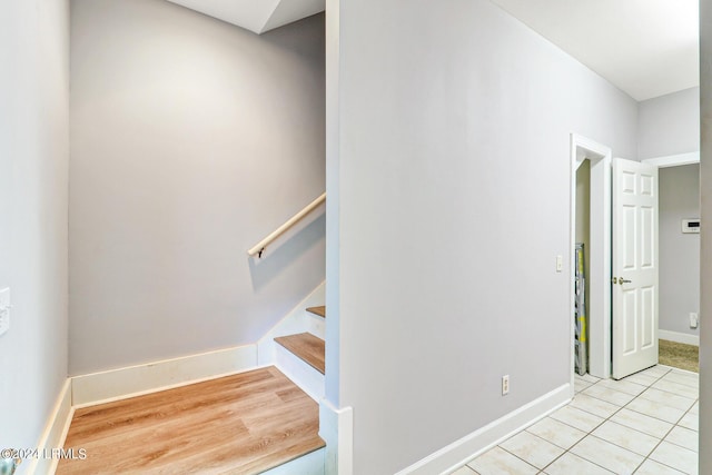 stairway featuring tile patterned flooring