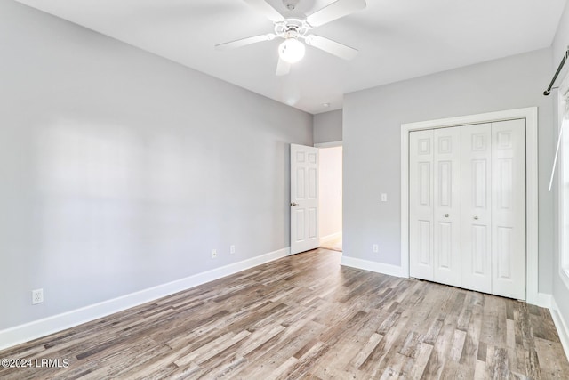 unfurnished bedroom with ceiling fan, a closet, and light wood-type flooring