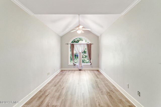 empty room featuring ceiling fan, lofted ceiling, and light hardwood / wood-style flooring