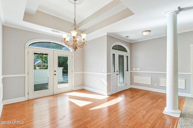 empty room featuring ornate columns, crown molding, and french doors