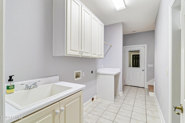 laundry area featuring sink, cabinets, light tile patterned floors, hookup for a washing machine, and hookup for an electric dryer