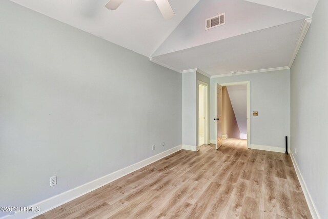 unfurnished room with light hardwood / wood-style flooring, vaulted ceiling, ornamental molding, and ceiling fan