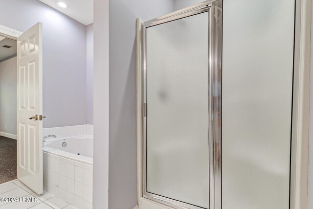 bathroom with tile patterned floors and separate shower and tub