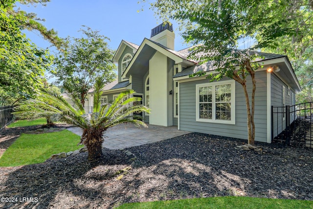 view of property exterior with a patio area