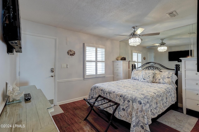 bedroom featuring wood-type flooring, a textured ceiling, and ceiling fan