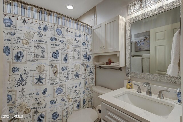 bathroom featuring vanity, a shower with curtain, and toilet