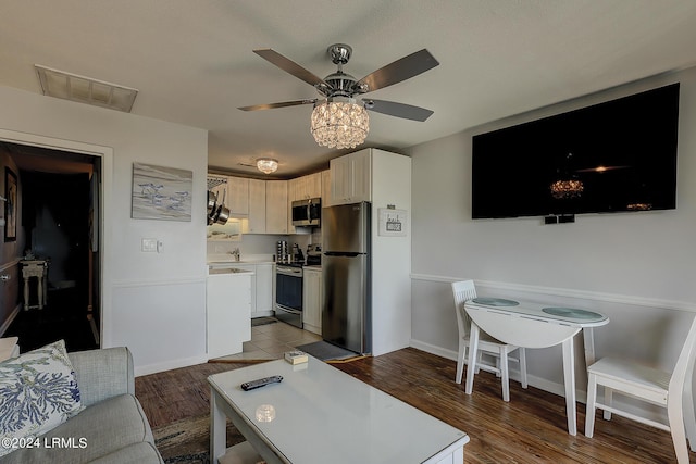 living room with ceiling fan and light hardwood / wood-style floors