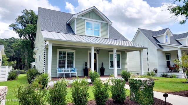 view of front of property with a porch and a front lawn