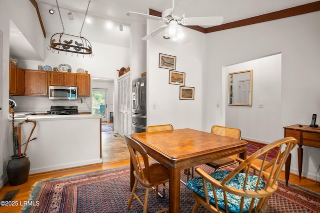 905 Gull Cv, Fripp Island, SC 29920 - dining area featuring light wood-style flooring, ceiling fan, and a high ceiling