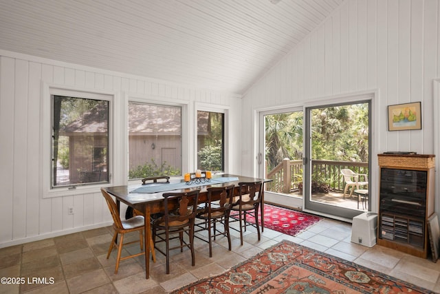905 Gull Cv, Fripp Island, SC 29920 - dining room featuring lofted ceiling, wood walls, and beverage cooler