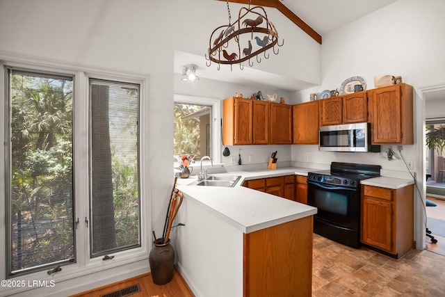 905 Gull Cv, Fripp Island, SC 29920 - kitchen featuring stainless steel microwave, black electric range, high vaulted ceiling, a peninsula, and light countertops