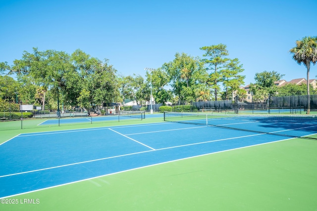 view of sport court featuring fence