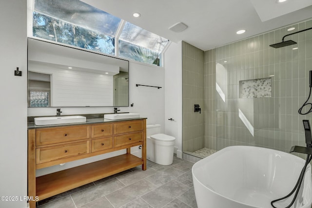 bathroom with a soaking tub, walk in shower, double vanity, and a sink