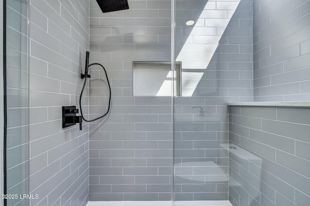 bathroom with tiled shower