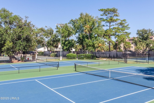 view of tennis court featuring fence