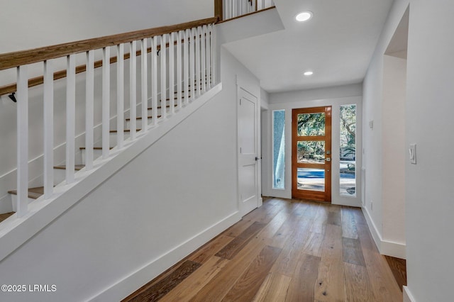 foyer entrance featuring recessed lighting, stairs, baseboards, and hardwood / wood-style floors