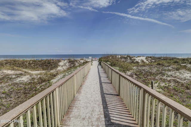 view of community with a beach view and a water view