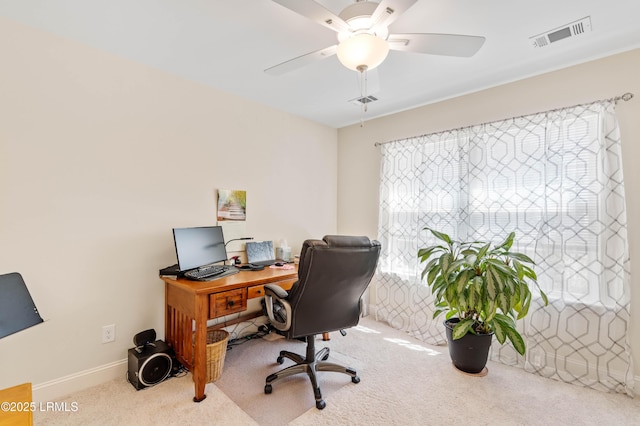 office area with visible vents, carpet floors, baseboards, and a ceiling fan