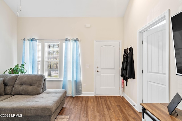 foyer entrance featuring baseboards and wood finished floors