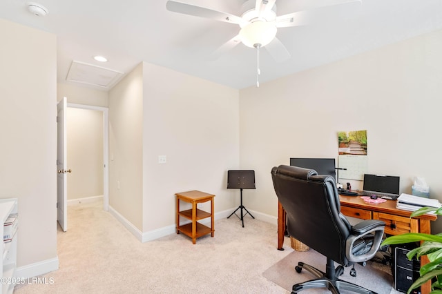 office area with ceiling fan, attic access, baseboards, and light carpet