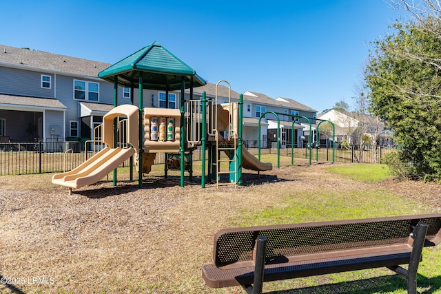 community play area with a residential view and fence