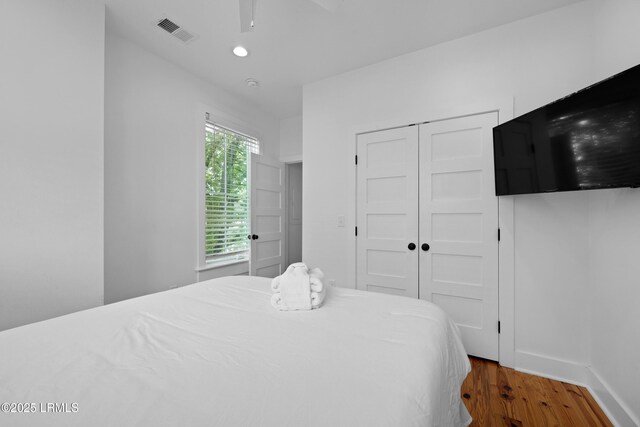 142 President St, Charleston, SC 29403 - bedroom featuring wood finished floors, a closet, baseboards, and a ceiling fan