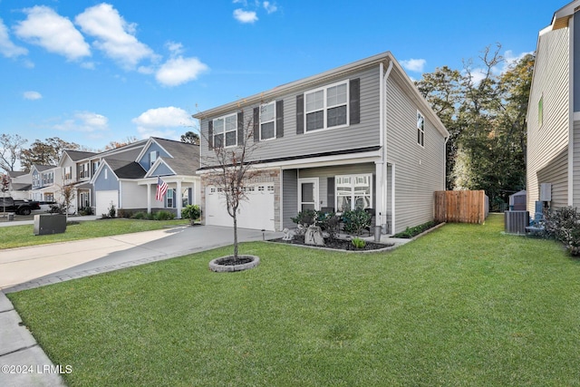 view of front of home with central AC, a garage, and a front yard