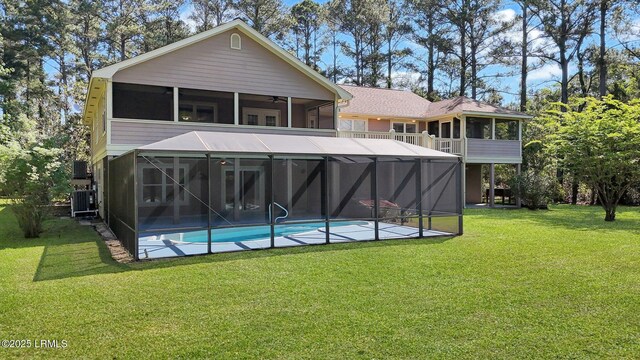 1812 Dolphin Row Dr, Beaufort, SC 29906 - back of property with an outdoor pool, ceiling fan, a yard, and a sunroom