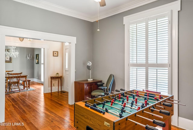 rec room featuring hardwood / wood-style flooring, ornamental molding, and ceiling fan