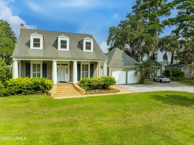 new england style home featuring a porch, a garage, and a front yard