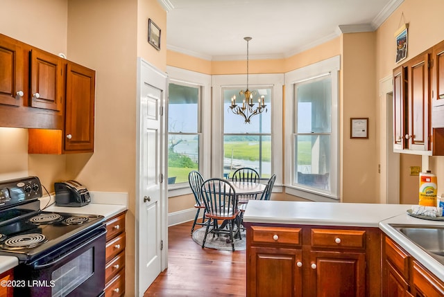 kitchen featuring decorative light fixtures, ornamental molding, dark hardwood / wood-style flooring, a notable chandelier, and black range with electric stovetop