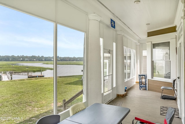 sunroom / solarium featuring a water view