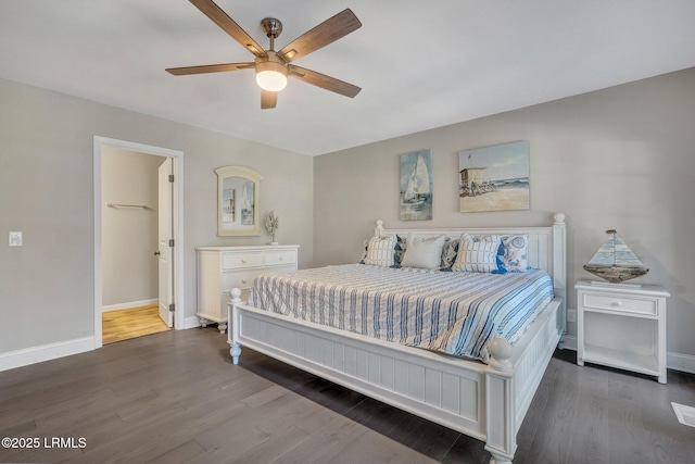 bedroom with a ceiling fan, wood finished floors, and baseboards