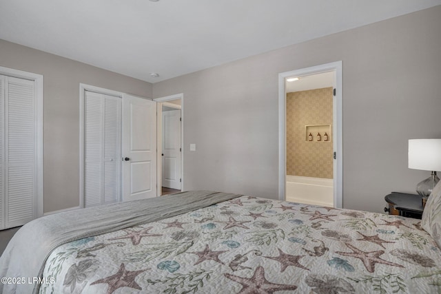 bedroom with connected bathroom and two closets