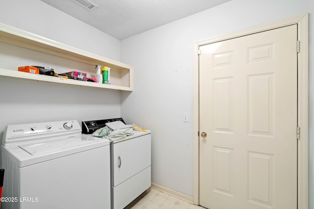 4 Moultrie Ct, Beaufort, SC 29907 - laundry room featuring washing machine and clothes dryer, a textured ceiling, baseboards, and light floors