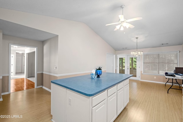 4 Moultrie Ct, Beaufort, SC 29907 - kitchen featuring light wood-style floors, vaulted ceiling, french doors, white cabinetry, and a center island