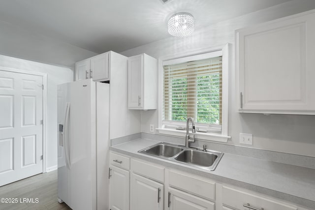 269 Ceasar Pl, Hilton Head Island, SC 29926 - kitchen featuring white refrigerator with ice dispenser, a sink, white cabinets, and light countertops