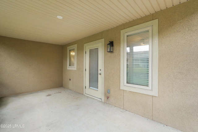 269 Ceasar Pl, Hilton Head Island, SC 29926 - doorway to property with stucco siding and a patio area