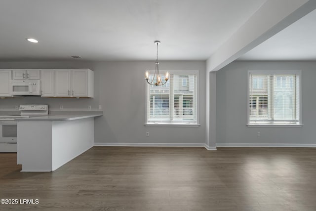 269 Ceasar Pl, Hilton Head Island, SC 29926 - kitchen featuring white appliances, healthy amount of natural light, white cabinetry, a chandelier, and recessed lighting