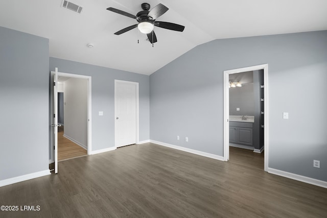 269 Ceasar Pl, Hilton Head Island, SC 29926 - unfurnished bedroom with vaulted ceiling, dark wood finished floors, baseboards, connected bathroom, and a sink