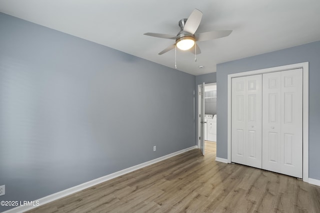 269 Ceasar Pl, Hilton Head Island, SC 29926 - unfurnished bedroom featuring independent washer and dryer, wood finished floors, baseboards, a closet, and a ceiling fan