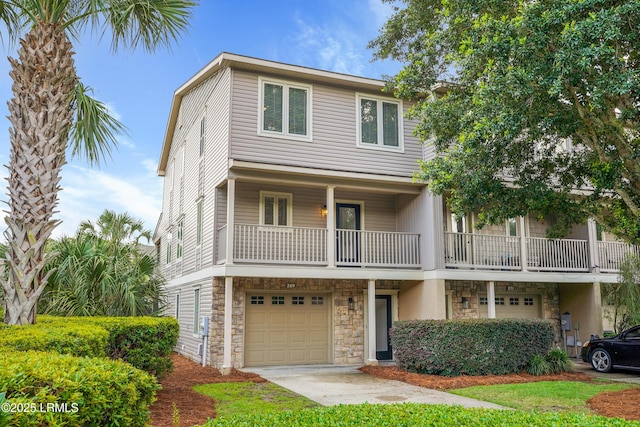 269 Ceasar Pl, Hilton Head Island, SC 29926 - townhome / multi-family property with stone siding, an attached garage, a balcony, and concrete driveway