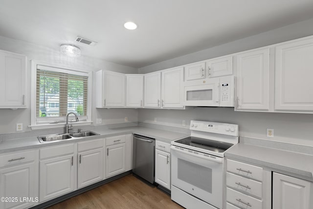 269 Ceasar Pl, Hilton Head Island, SC 29926 - kitchen featuring white appliances, a sink, white cabinetry, light countertops, and recessed lighting