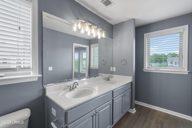 269 Ceasar Pl, Hilton Head Island, SC 29926 - full bathroom featuring double vanity, wood finished floors, toilet, and baseboards