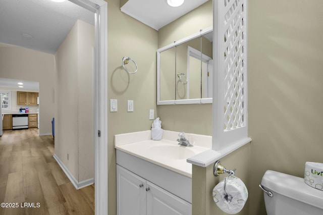 70 Shipyard Dr Unit 166, Hilton Head Island, SC 29928 - half bathroom featuring wood finished floors, toilet, vanity, and baseboards
