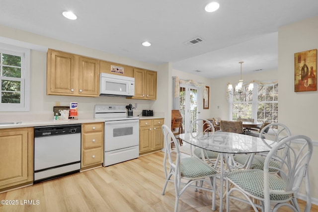 70 Shipyard Dr Unit 166, Hilton Head Island, SC 29928 - kitchen featuring white appliances, a chandelier, light wood-style floors, light countertops, and recessed lighting