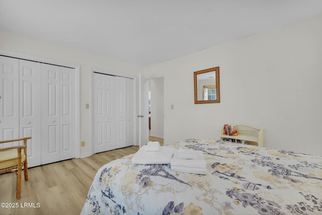 70 Shipyard Dr Unit 166, Hilton Head Island, SC 29928 - bedroom with multiple closets, light wood-style flooring, and baseboards